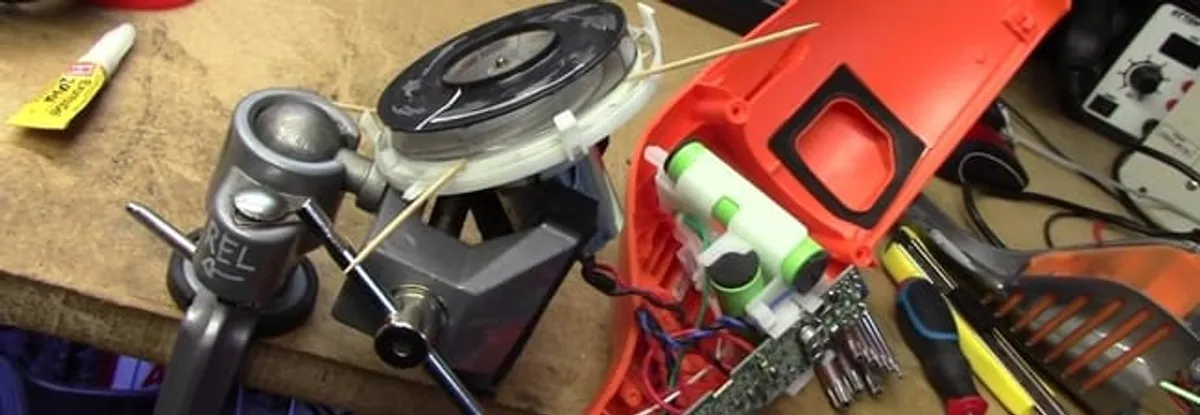 Vacuum cleaner repair parts and tools on a workbench in Huntsville, AL